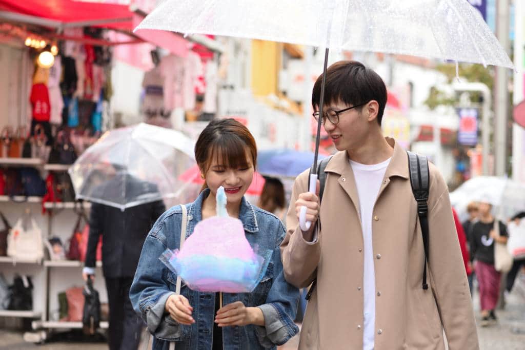 couple eating rainbow cotton candy in Harajuku, Tokyo