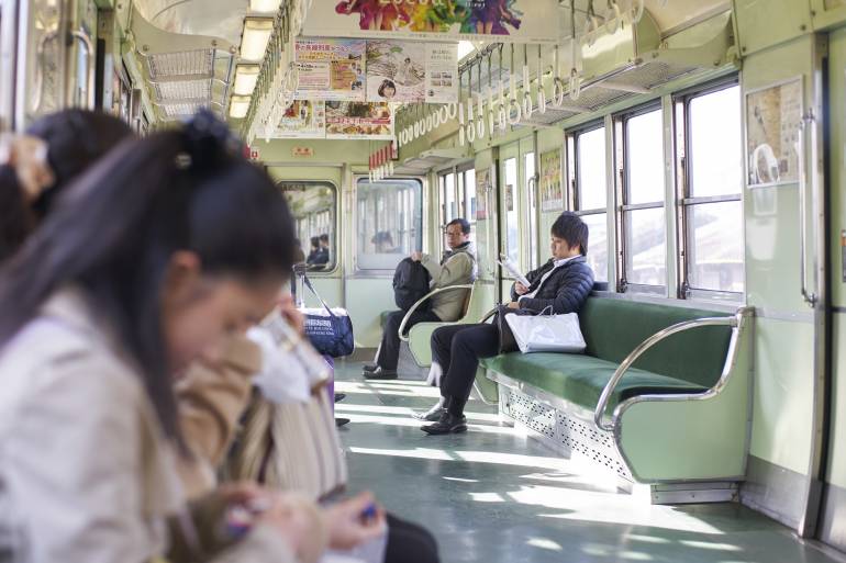 People riding a local train in Japan