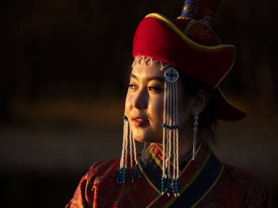 Portrait of a young woman in traditional Mongolian dress.