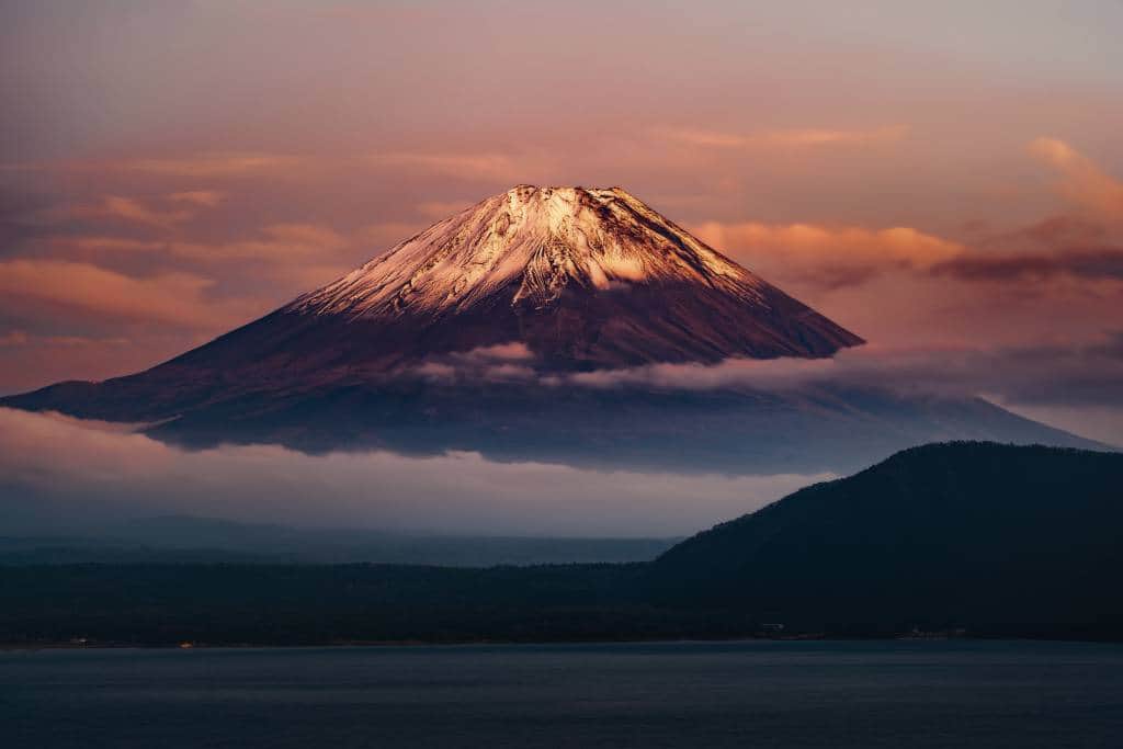 Mt Fuji at dawn, shrouded in clouds, with with Lake Kawaguchiko in the foreground, Japan
