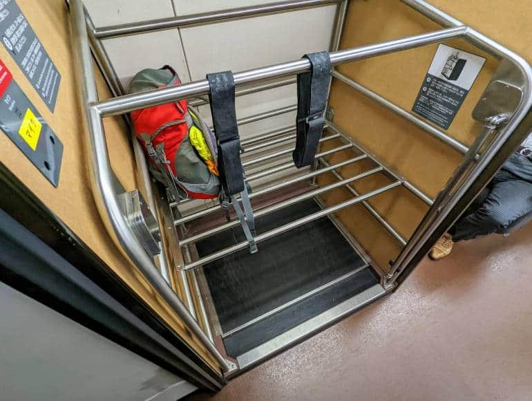 A luggage rack on the hokuriku shinkansen with a single backpack.